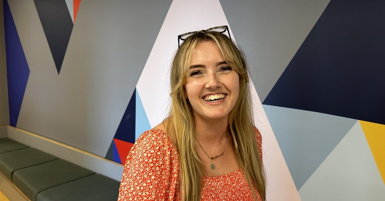 Consultant Victoria Brownsell in front of colourful background