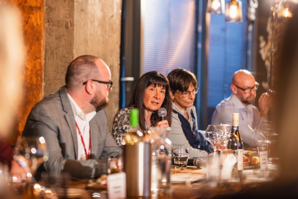 Eman Al-Hillawi talks on the mic at the roundtable